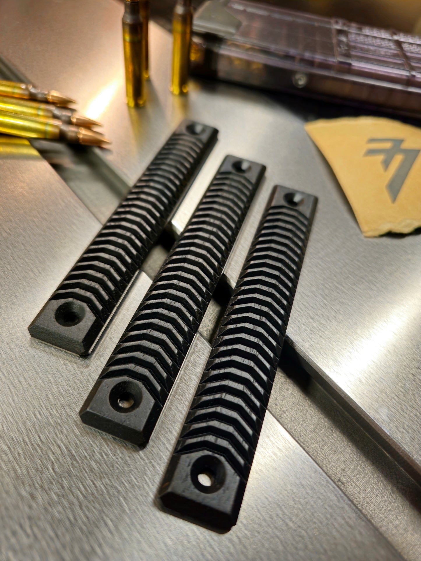 A set of blackout Walnut wood 3 slot mlok rail panels for a ar15 m-lok handguard rail. V blunt texture