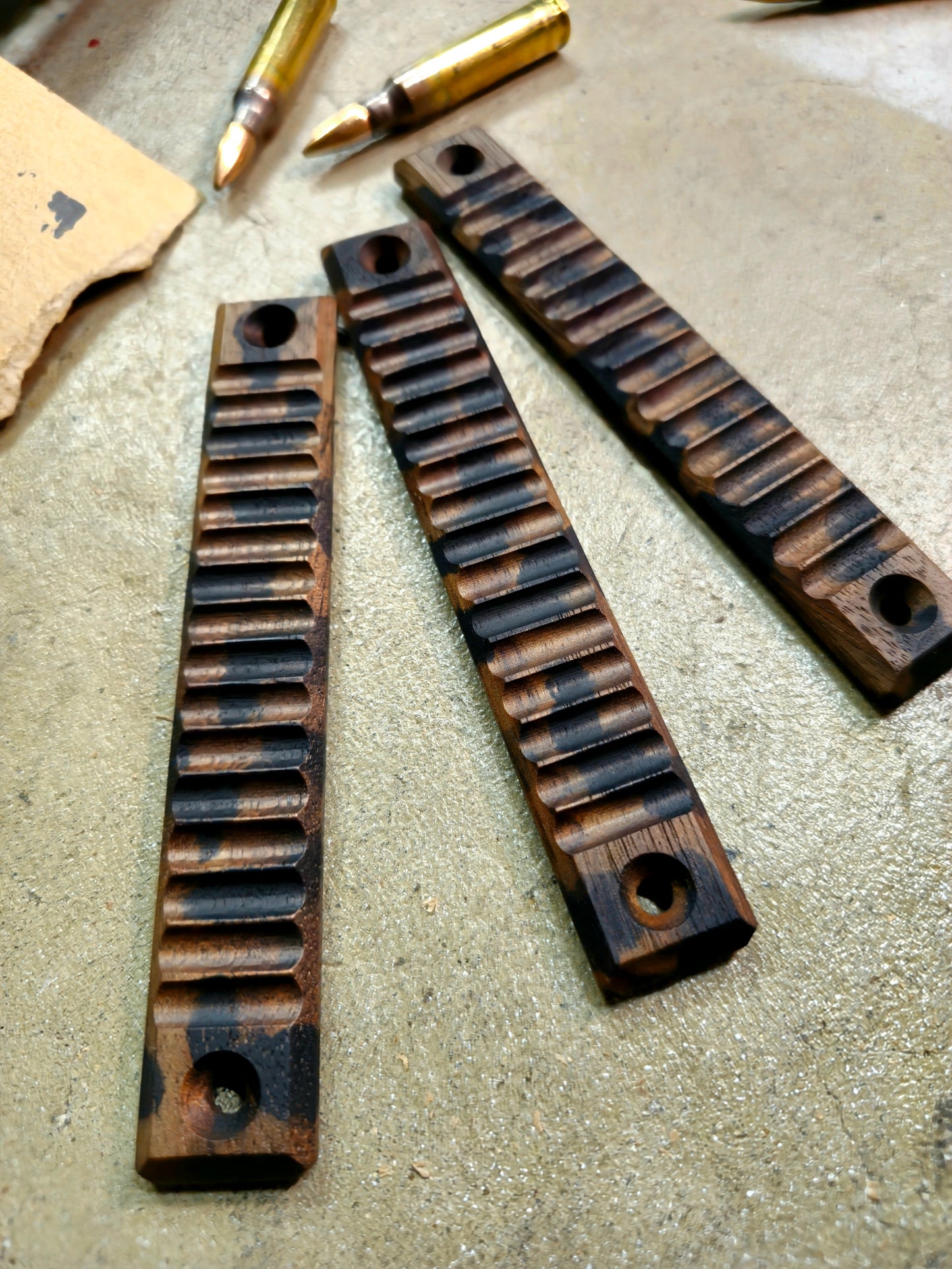 Top angled view of a set of 3 slot wood mlok handguard covers in black camo Ribbed texture