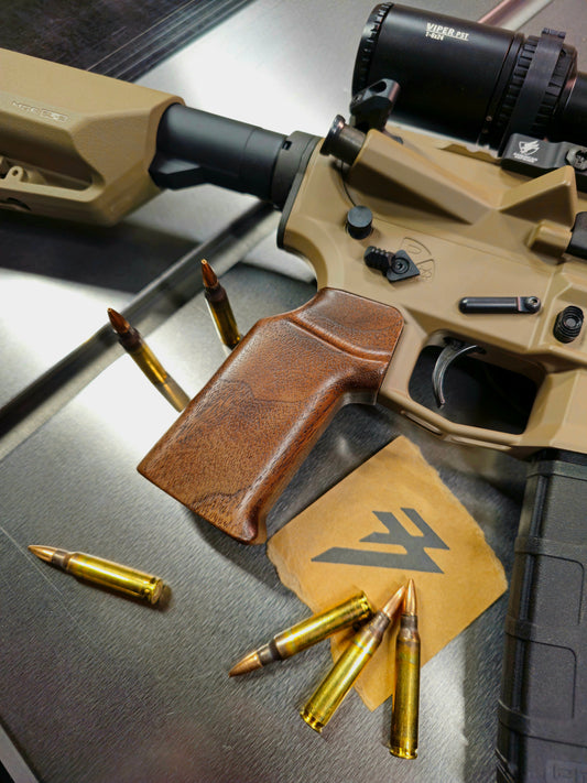 Close up photo of a wood ar15 grip attached