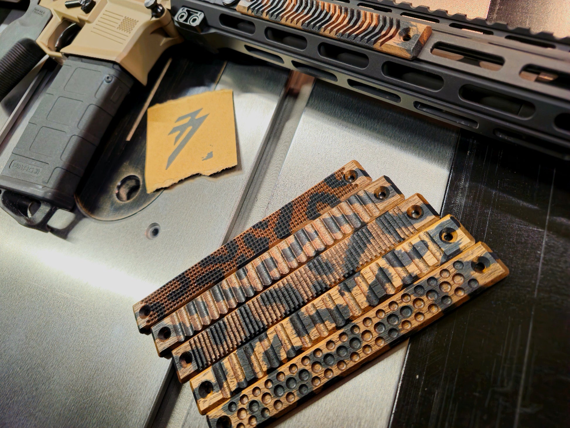 Top view of all 5 texture options of the 4 slot wood mlok handguard covers in black camo